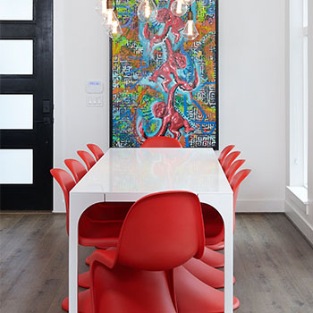 White table, red chairs and colorful picture image